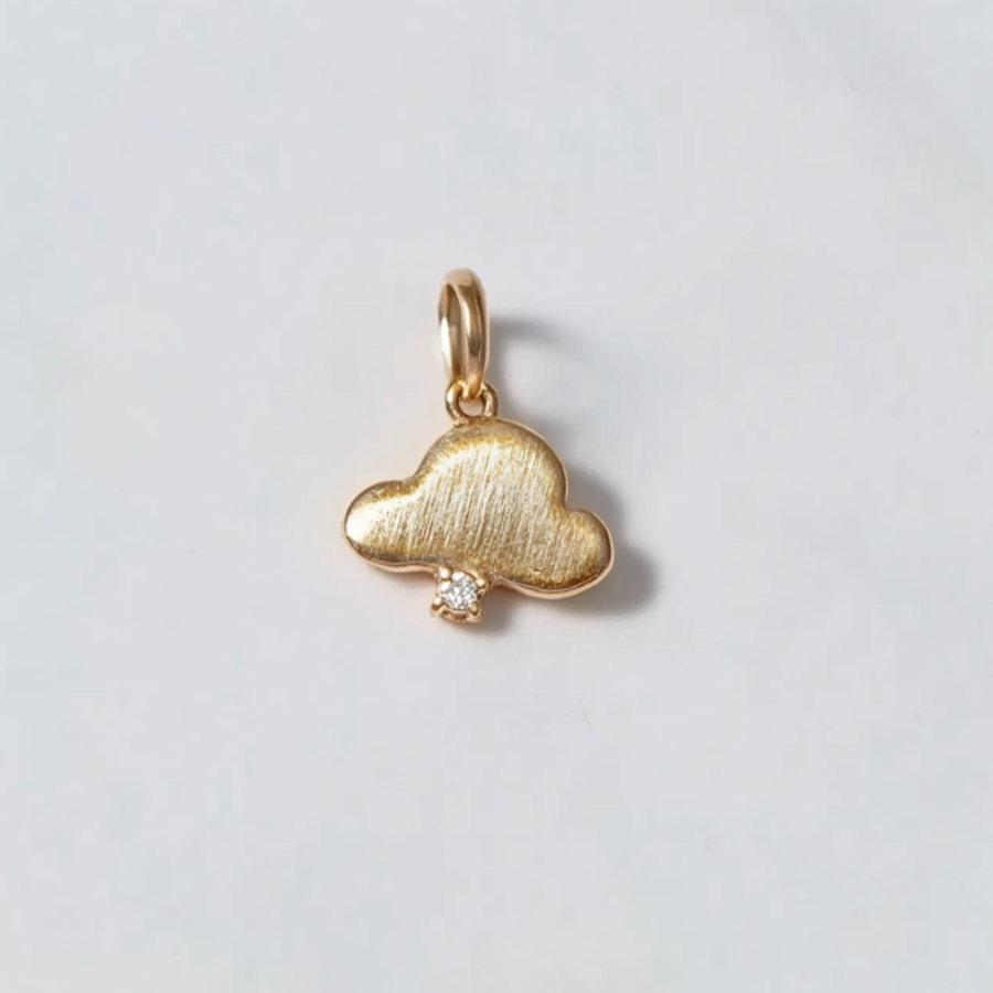 A 14k gold charm shaped like a cloud with a diamond in the center, presented on a white background.