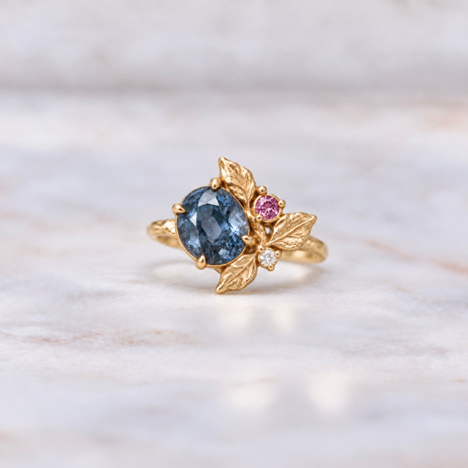 Botanical blue sapphire engagement ring in yellow gold