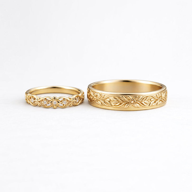 Two gold rings with intricate designs on a white background