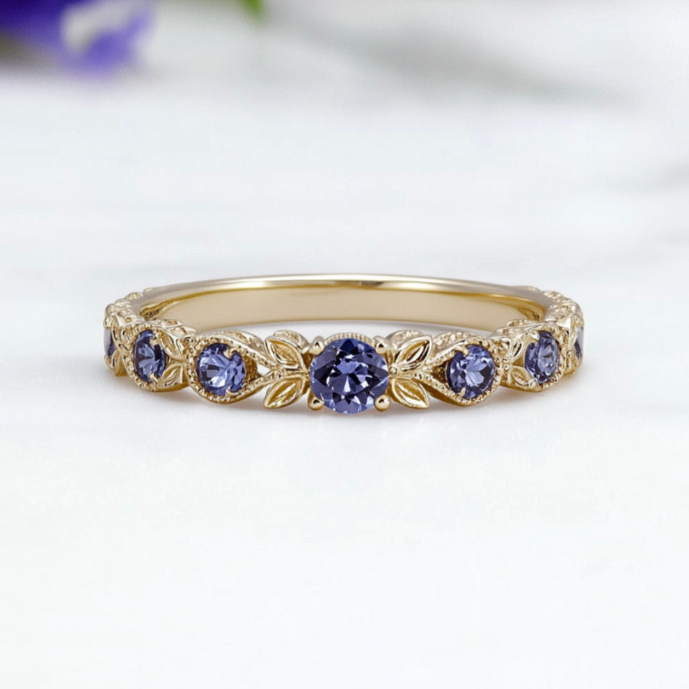 Gold band with purple gemstones on a white background