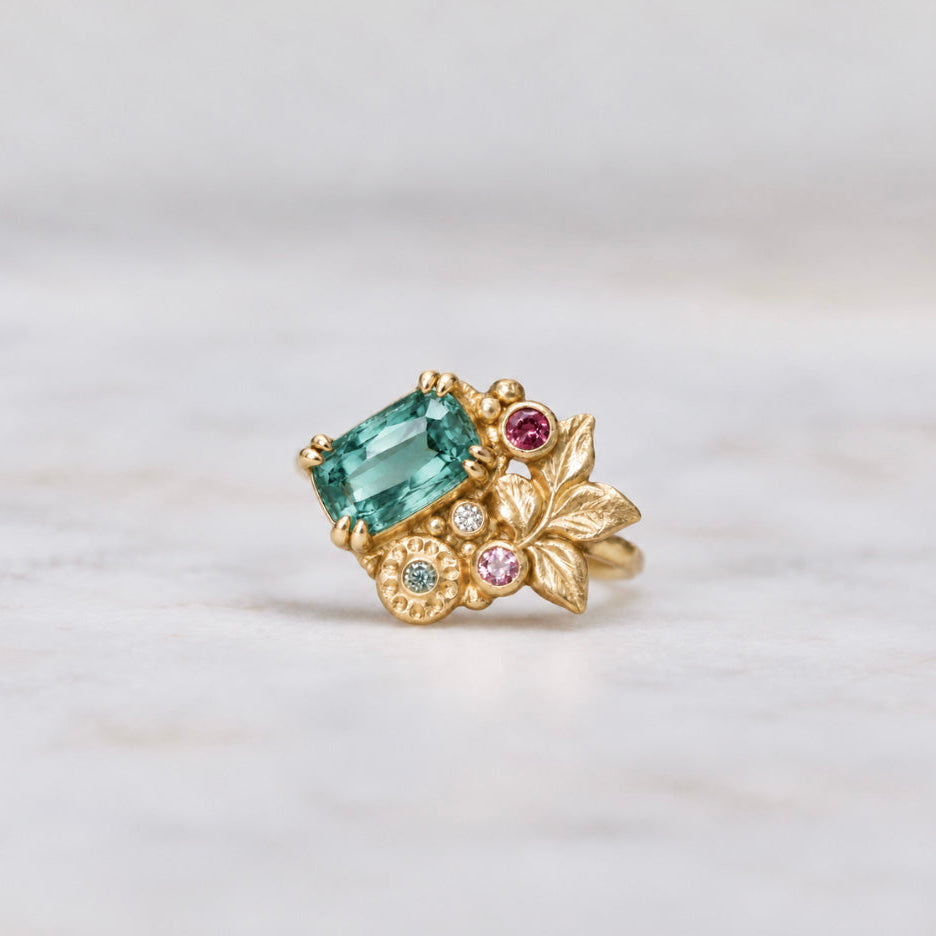Green blue tourmaline engagement ring in yellow gold