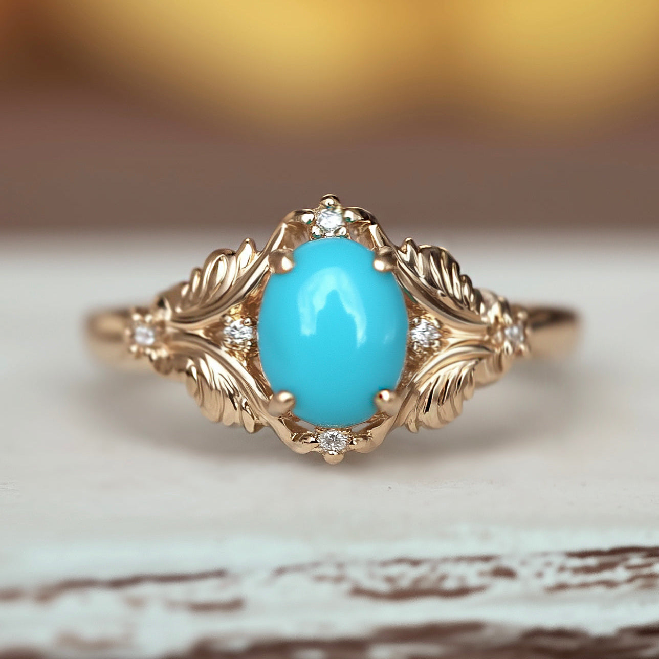 Gold ring with a turquoise stone on a wooden surface