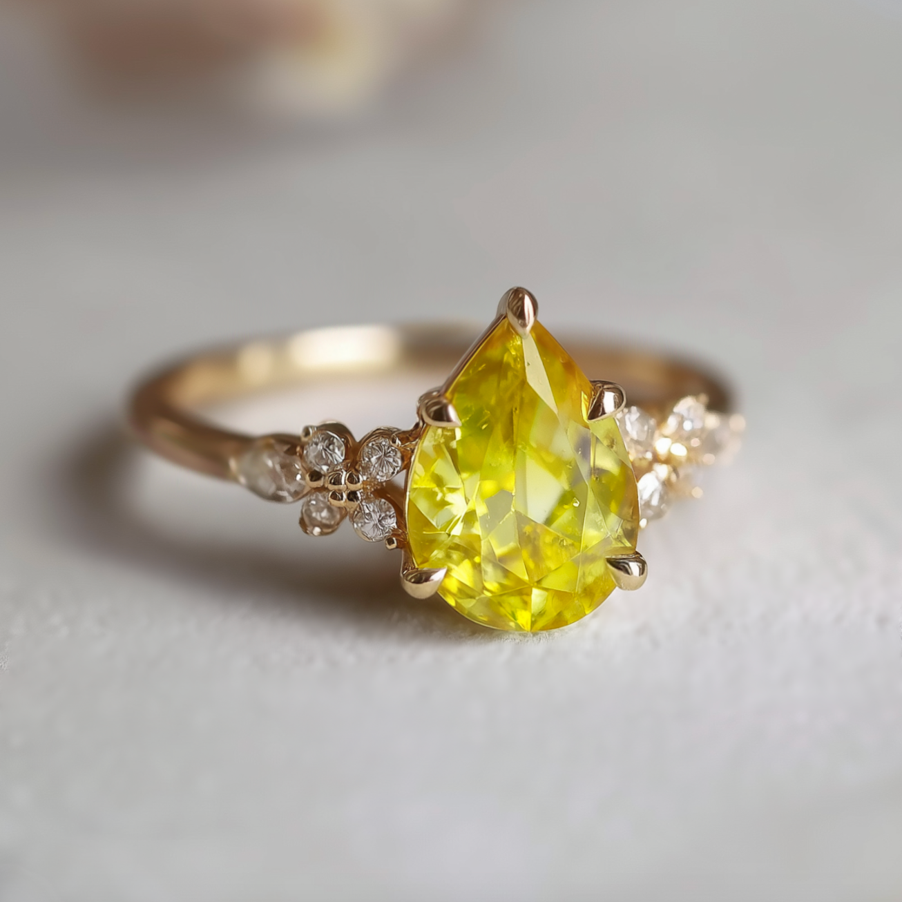 Gold ring with a yellow pear-shaped gemstone