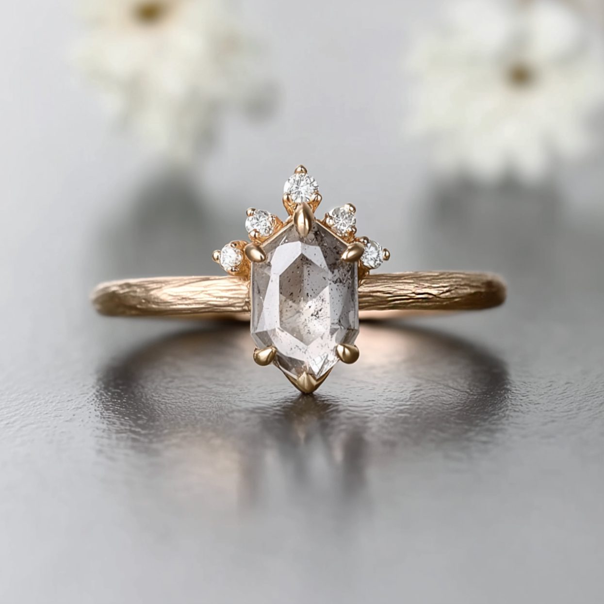 Gold ring with a large diamond and smaller diamonds on a light background