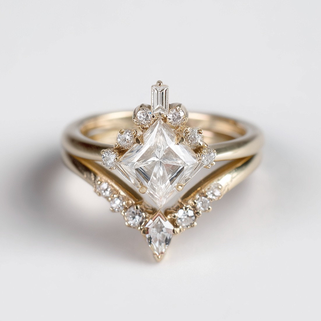 Gold ring with a large diamond and smaller diamonds on a light gray background