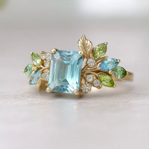 Elegant ring with a large blue gemstone and smaller green and blue stones on the shank