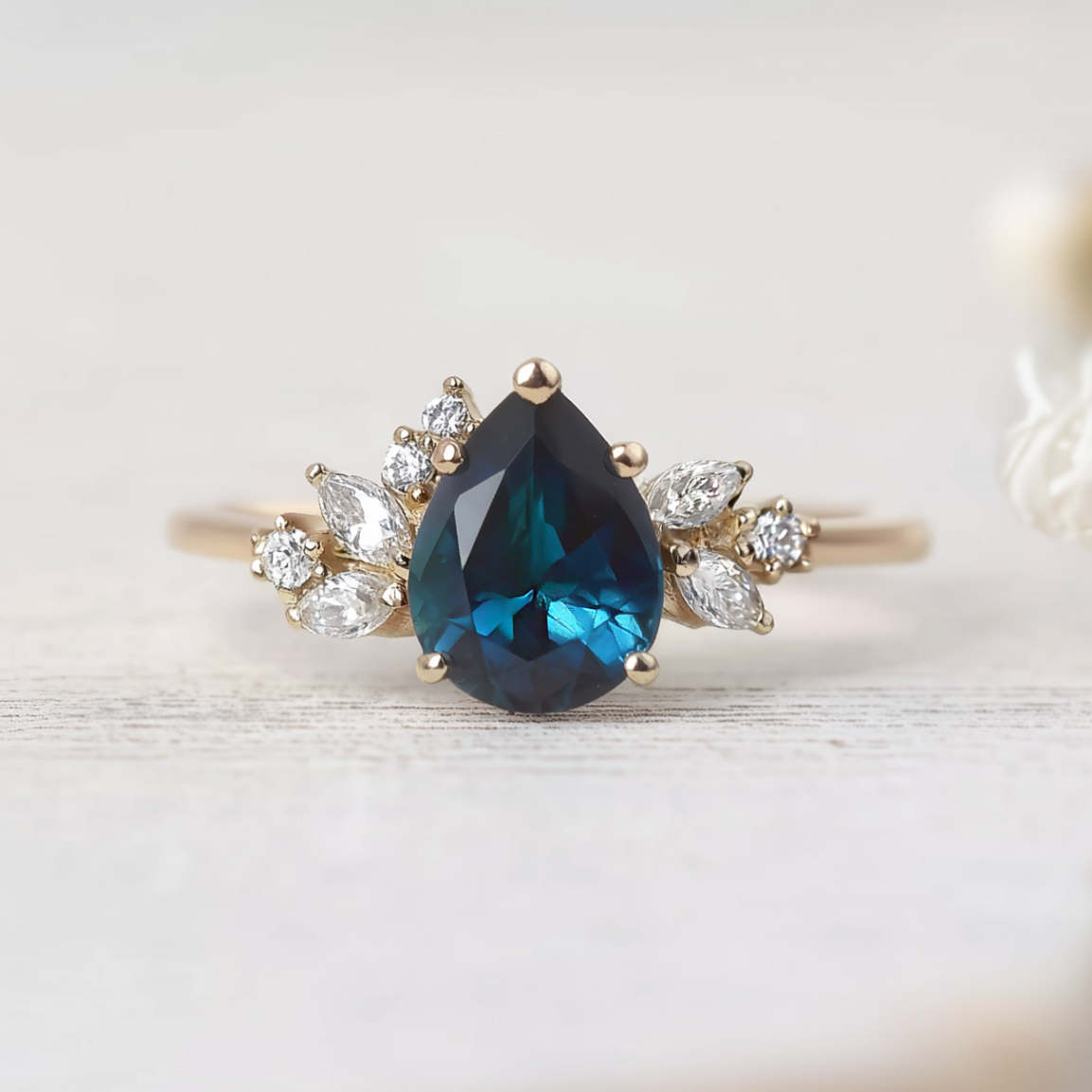 Ring with a blue gemstone and diamond accents on a light background