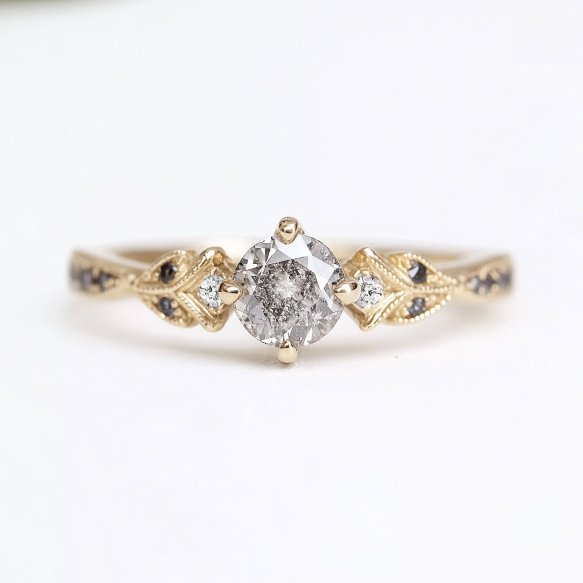 Gold ring with a diamond on a white background