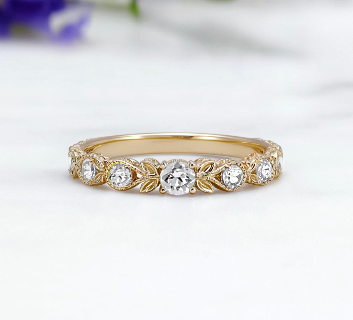 Gold ring with diamond stones on a white background