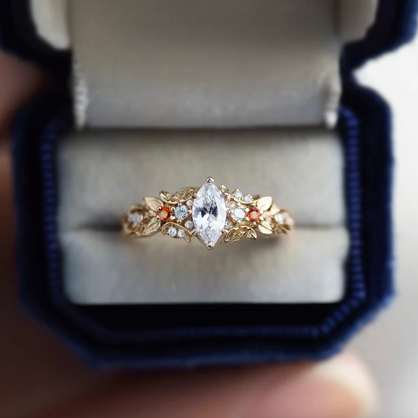 Gold ring with a central diamond in an open jewelry box