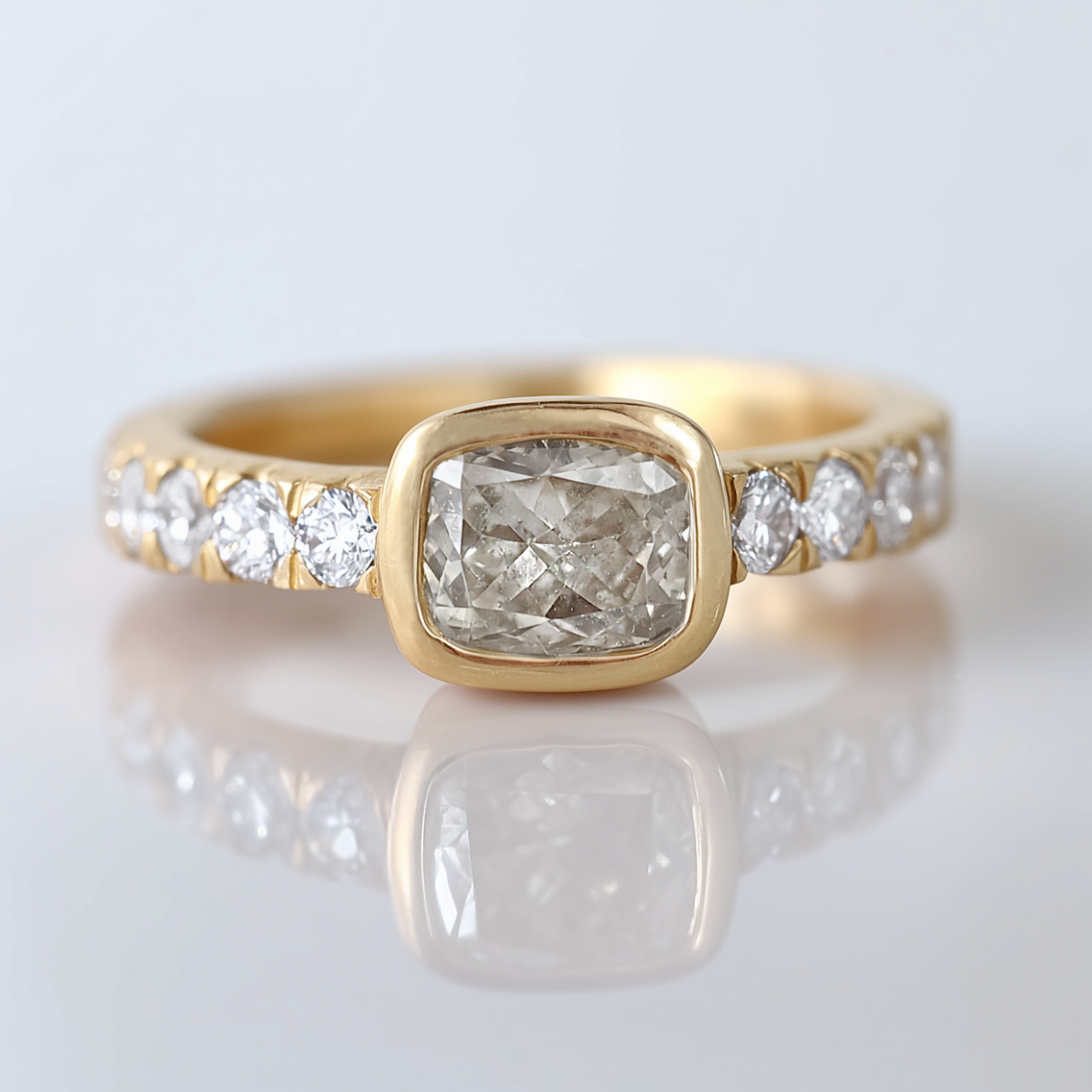 Gold ring with a diamond on a light gray background