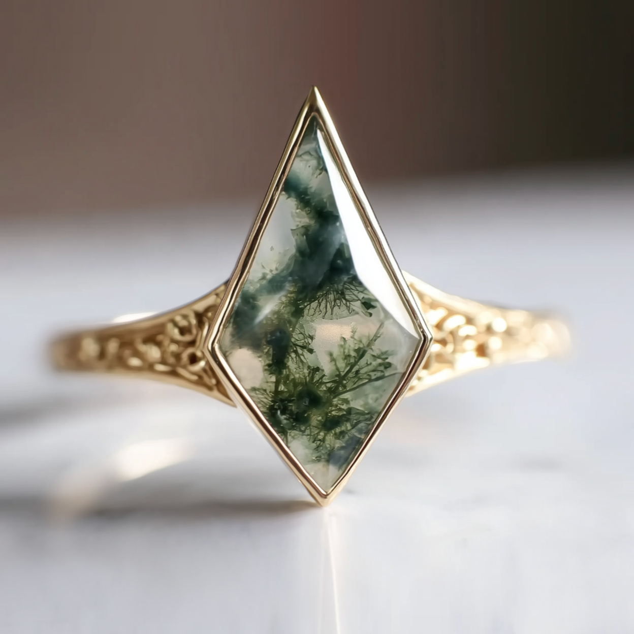 Gold ring with a green stone on a light background