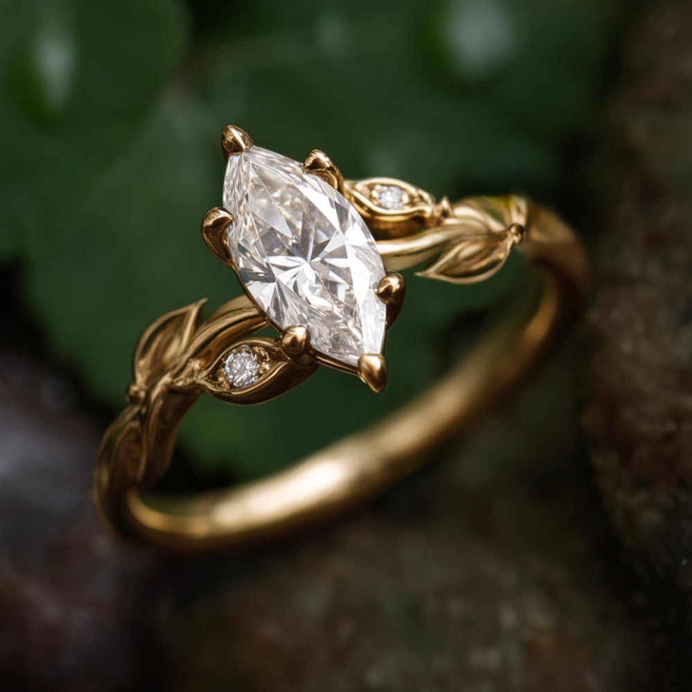 Gold ring with a marquise-shaped diamond on a natural background