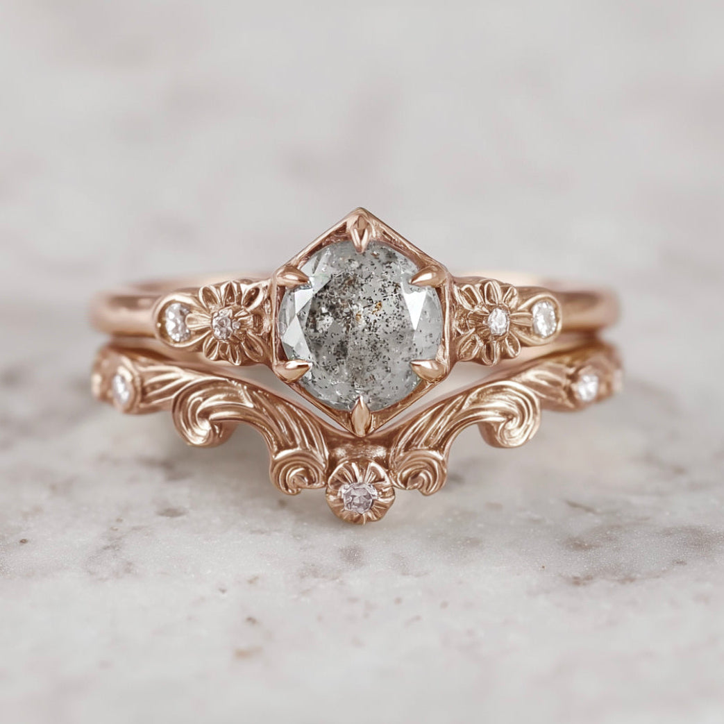 Rose gold ring with a diamond on a marble surface