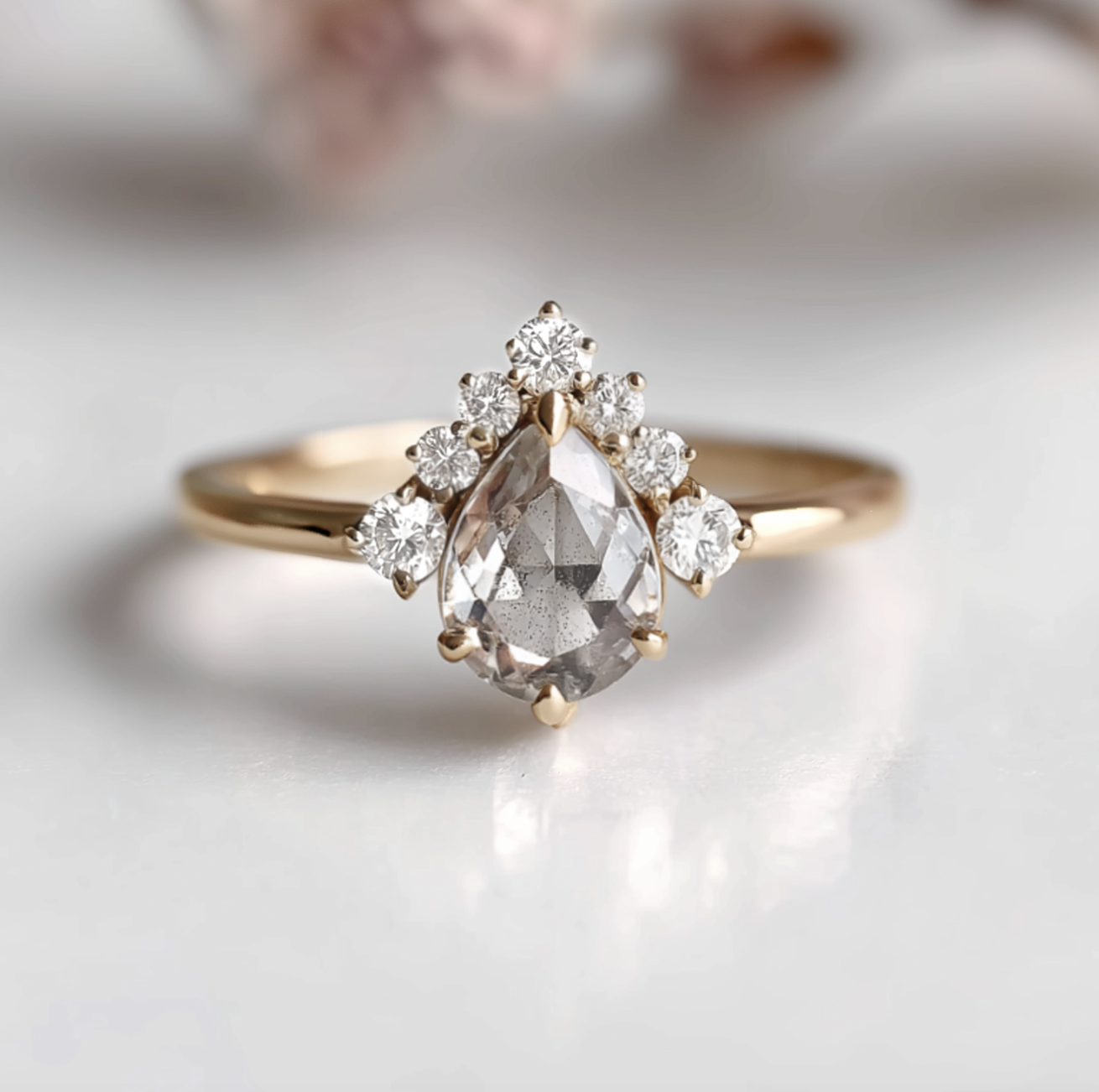 Gold ring with a central diamond and smaller diamonds on a light background