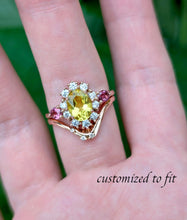 Load image into Gallery viewer, Ring with a yellow gemstone on a hand against a green background
