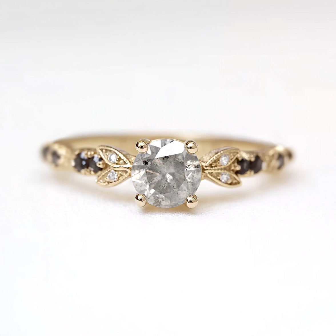Gold ring with a diamond on a white background